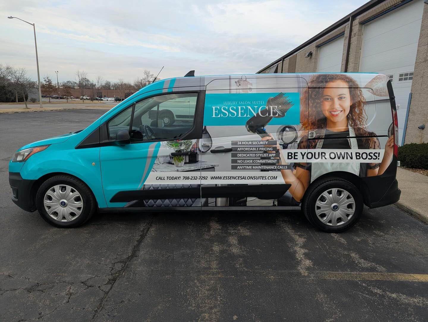 Side of the teal Essence van wrap: salon photography, a BE YOUR OWN BOSS headline and the salon suites' contact details.
