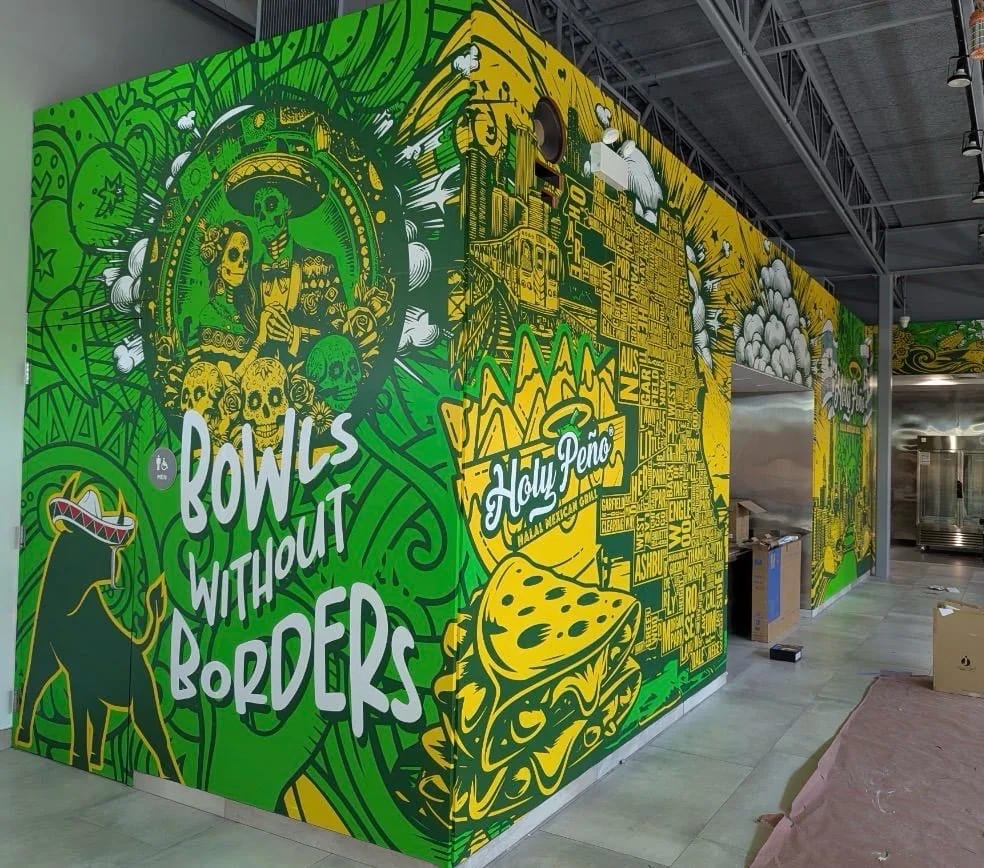 Green and yellow illustrated mural reading BOWLS WITHOUT BORDERS beside the Holy Peño logo on an exterior wall.